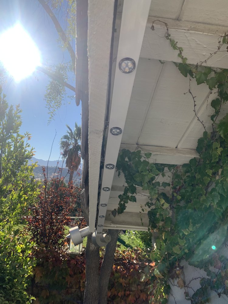 Daytime close-up of the low-profile LED track tucked under the eave